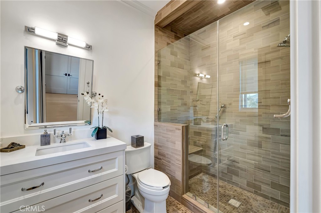 2037 Delphine Lane Calabasas, CA 91302 - Photo 41 of 75 a bathroom with a sink a toilet a mirror and shower