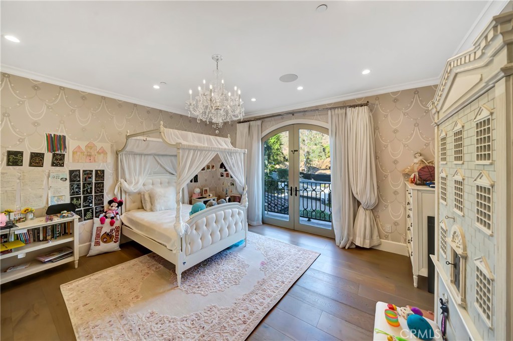 2037 Delphine Lane Calabasas, CA 91302 - Photo 42 of 75 a bedroom with furniture and a chandelier