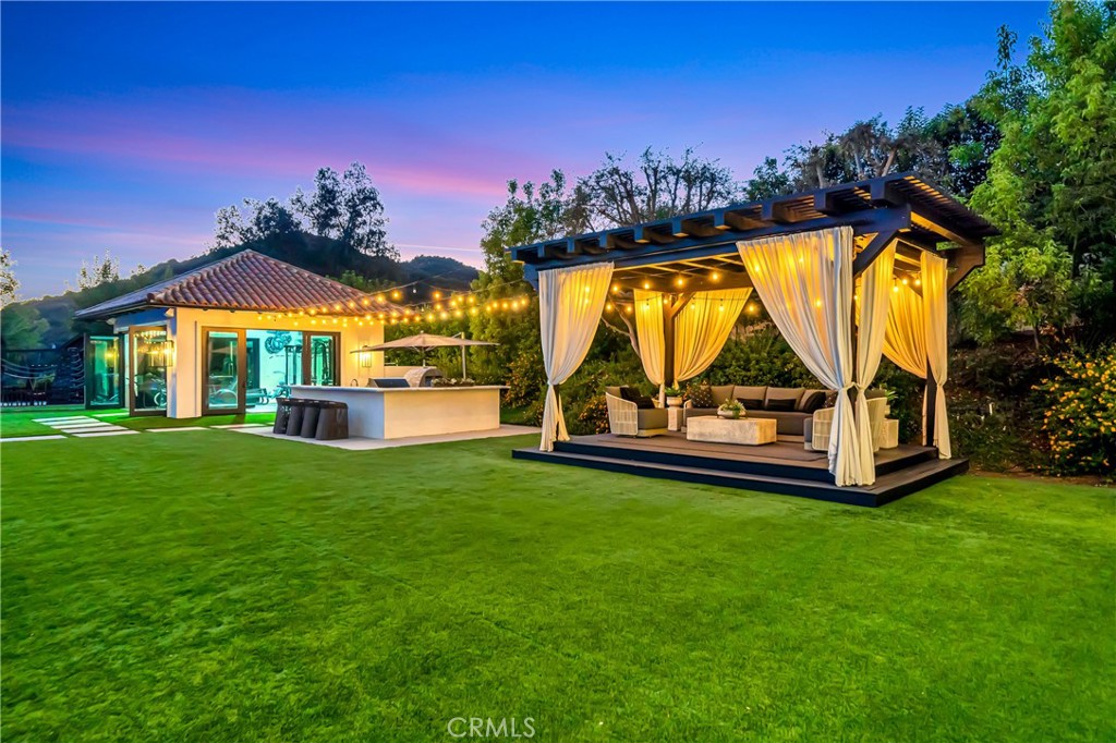 2037 Delphine Lane Calabasas, CA 91302 - Photo 54 of 75 a view of a house with a swimming pool and a yard