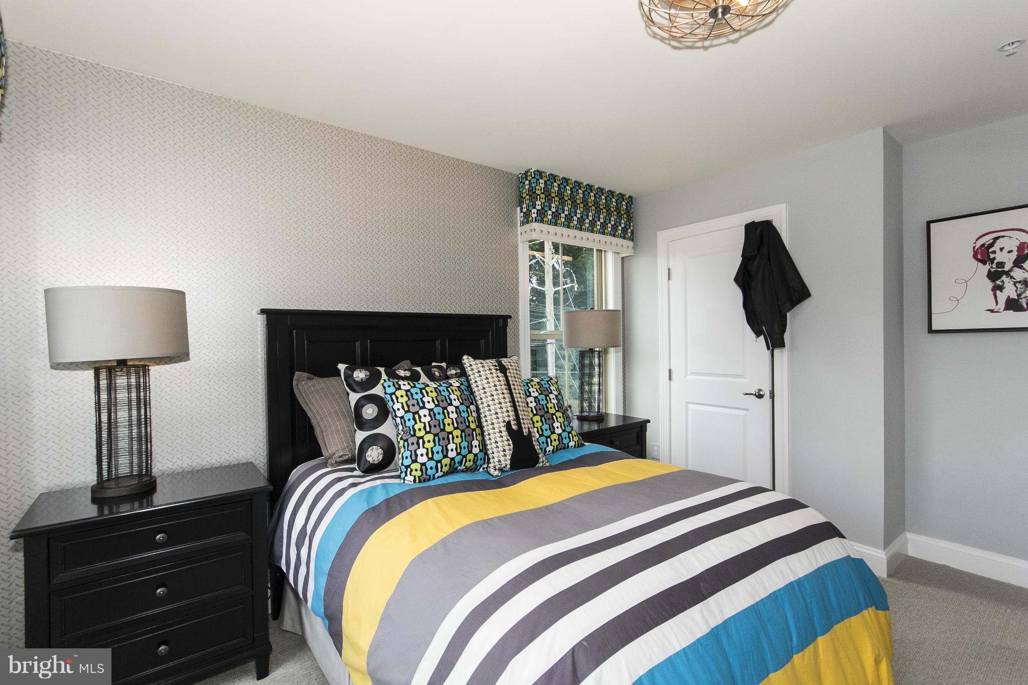 4200 Perry Hall Road Perry Hall, MD 21128 - Photo 22 of 30 a bedroom with a bed and a lamp on the dresser