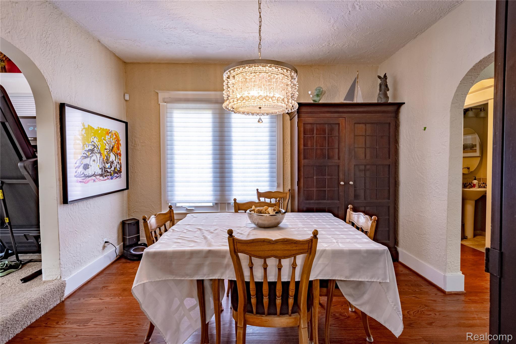 5630 Lakeshore Road Fort Gratiot, MI 48059 - Photo 20 of 49 Dining area featuring warm wood-finish flooring and a distinctive crystal-style chandelier