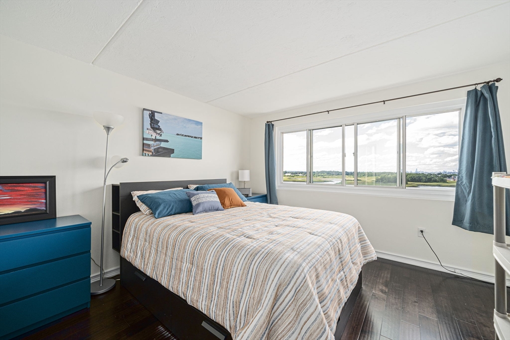 200 Cove Way, Unit 1012 Quincy, MA 02169 - Photo 11 of 26 a bedroom with a bed and a large window
