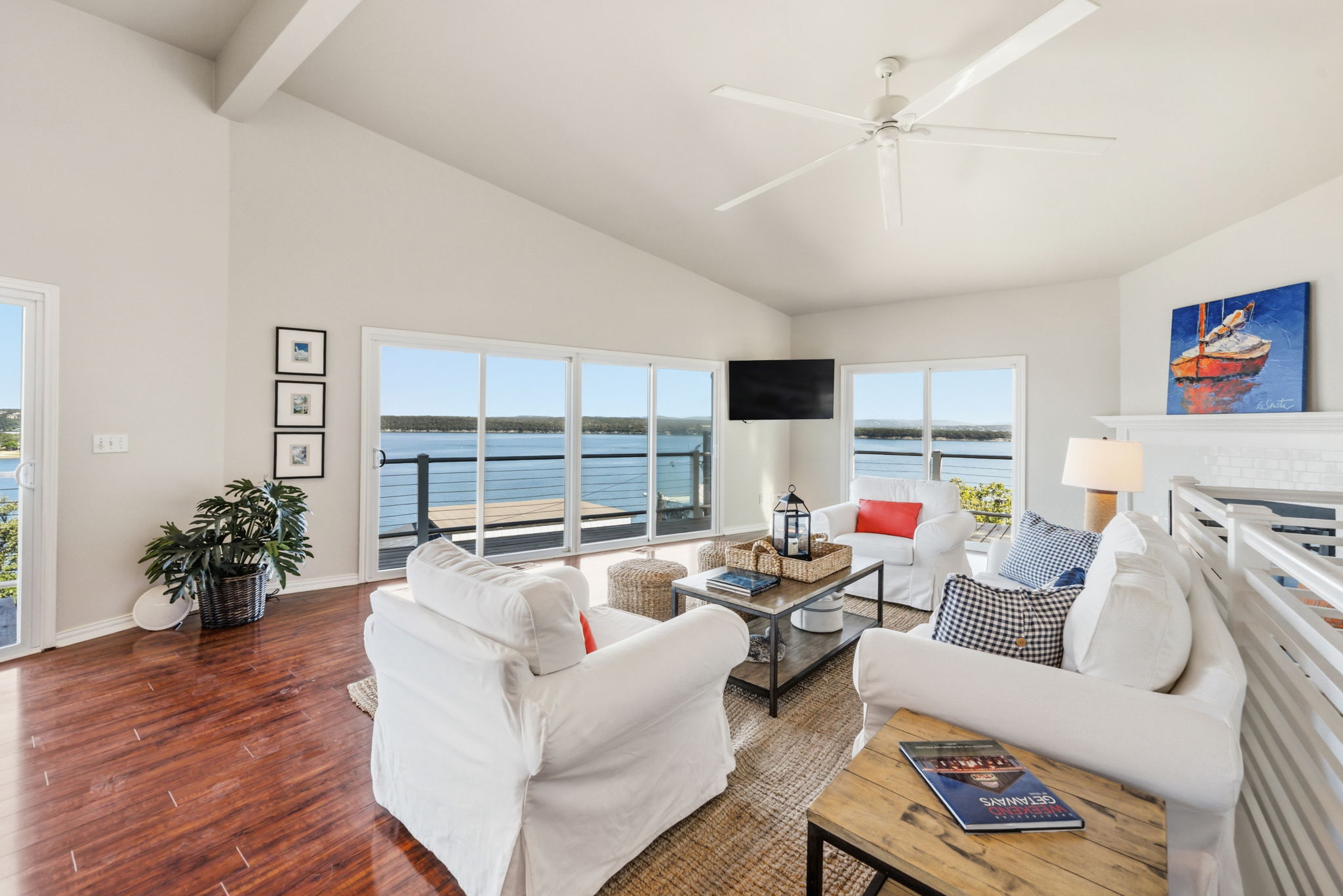 1715 Buffalo Gap Road Austin, TX 78734 - Photo 5 of 18 Gleaming hardwood floors and vaulted ceilings frame spectacular views of the water through sliding doors.