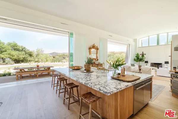 a kitchen with granite countertop lots of counter top space and living room