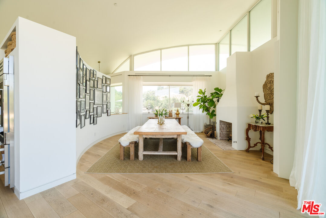 1750 Will Geer Road Topanga, CA 90290 - Photo 11 of 49 a living room with furniture a table and white walls