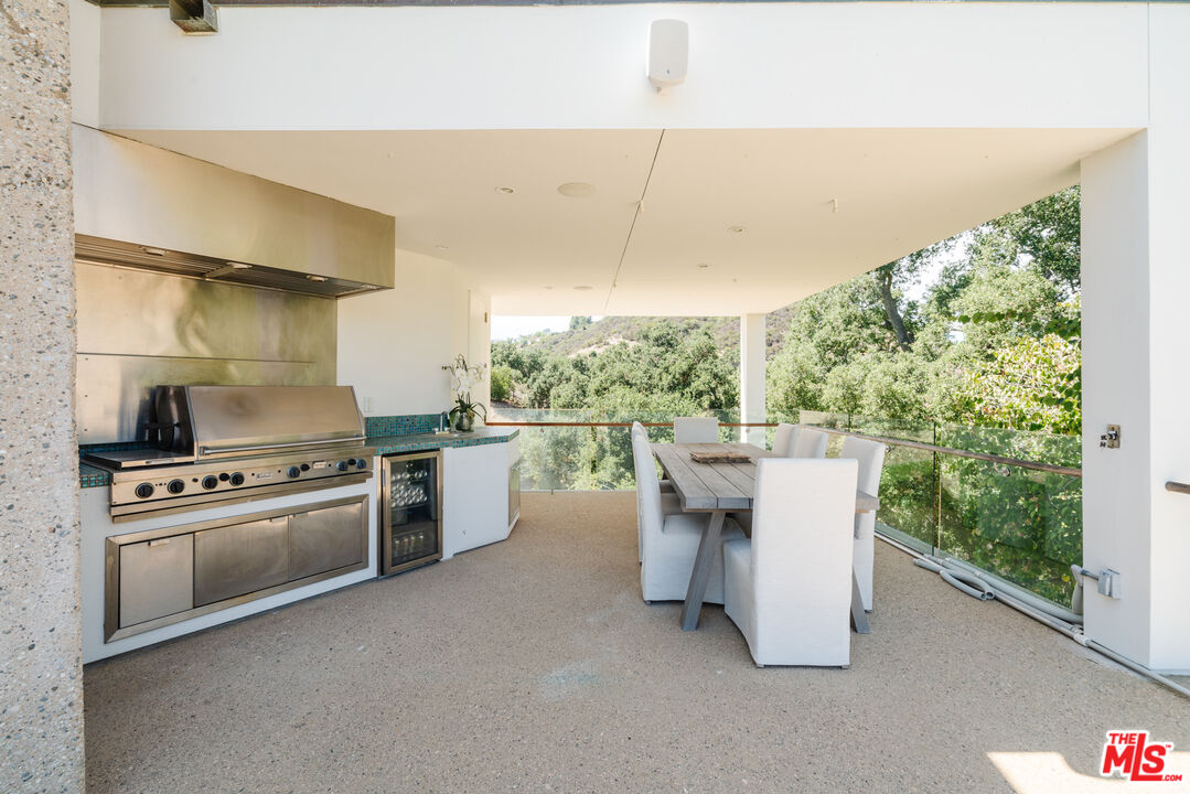 1750 Will Geer Road Topanga, CA 90290 - Photo 17 of 49 a kitchen with a stove a sink and a refrigerator