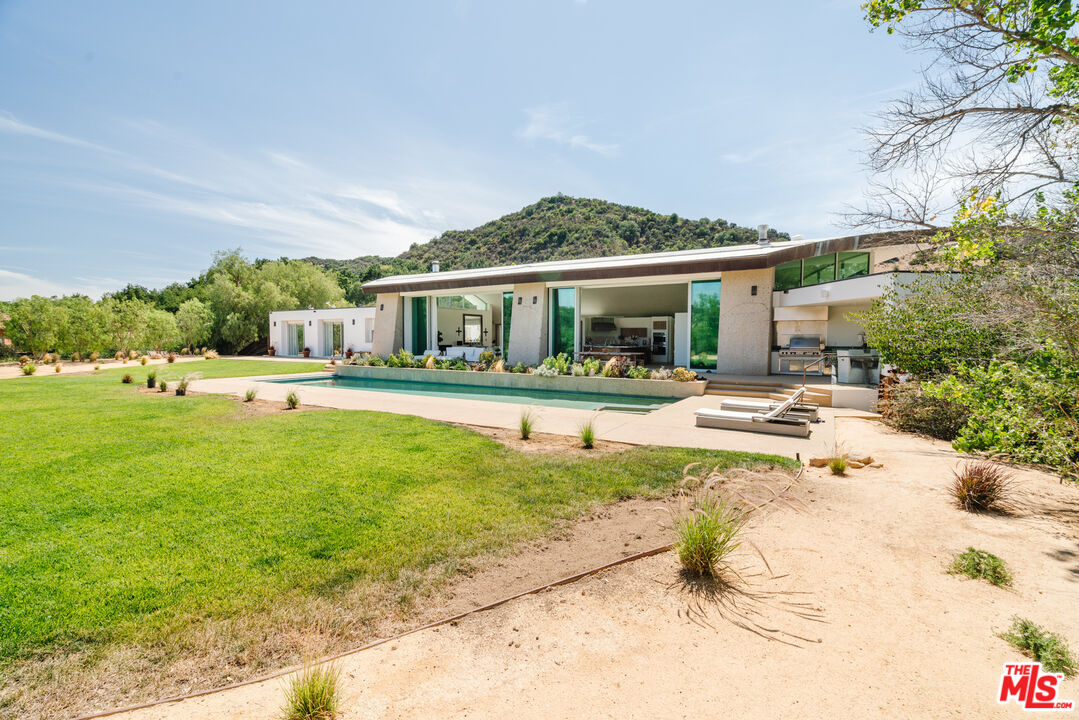 1750 Will Geer Road Topanga, CA 90290 - Photo 20 of 49 a view of a house with a yard patio and swimming pool