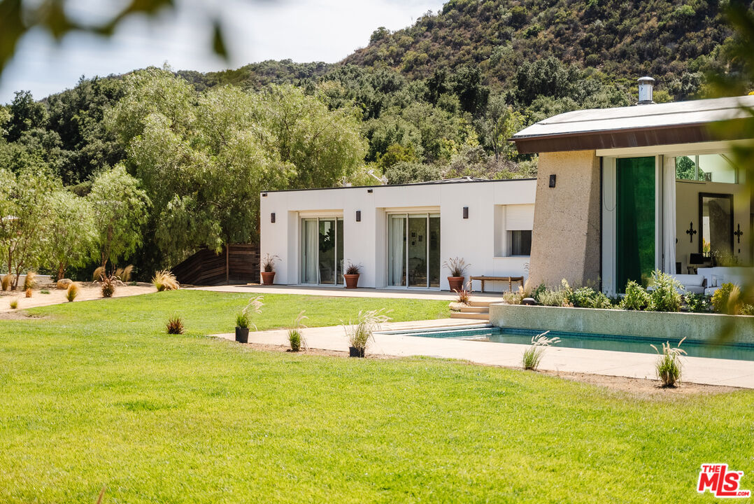 1750 Will Geer Road Topanga, CA 90290 - Photo 21 of 49 a view of a house with swimming pool and yard