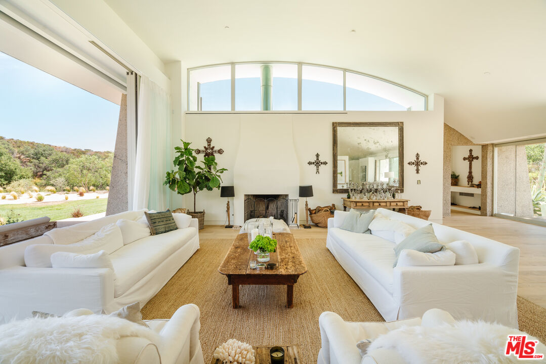 1750 Will Geer Road Topanga, CA 90290 - Photo 4 of 49 a living room with furniture fireplace and a large window