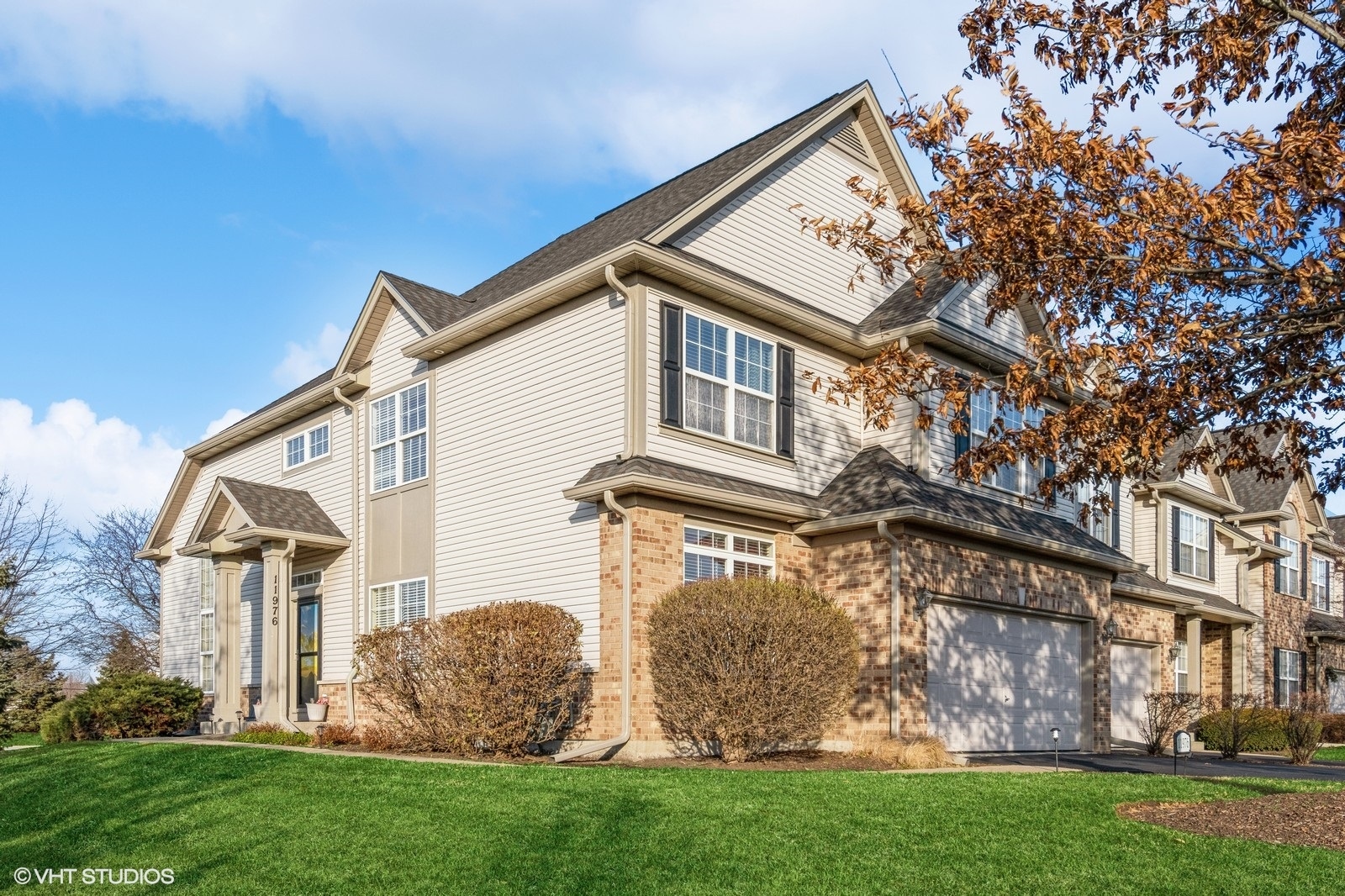 a front view of a house with a garden and plants