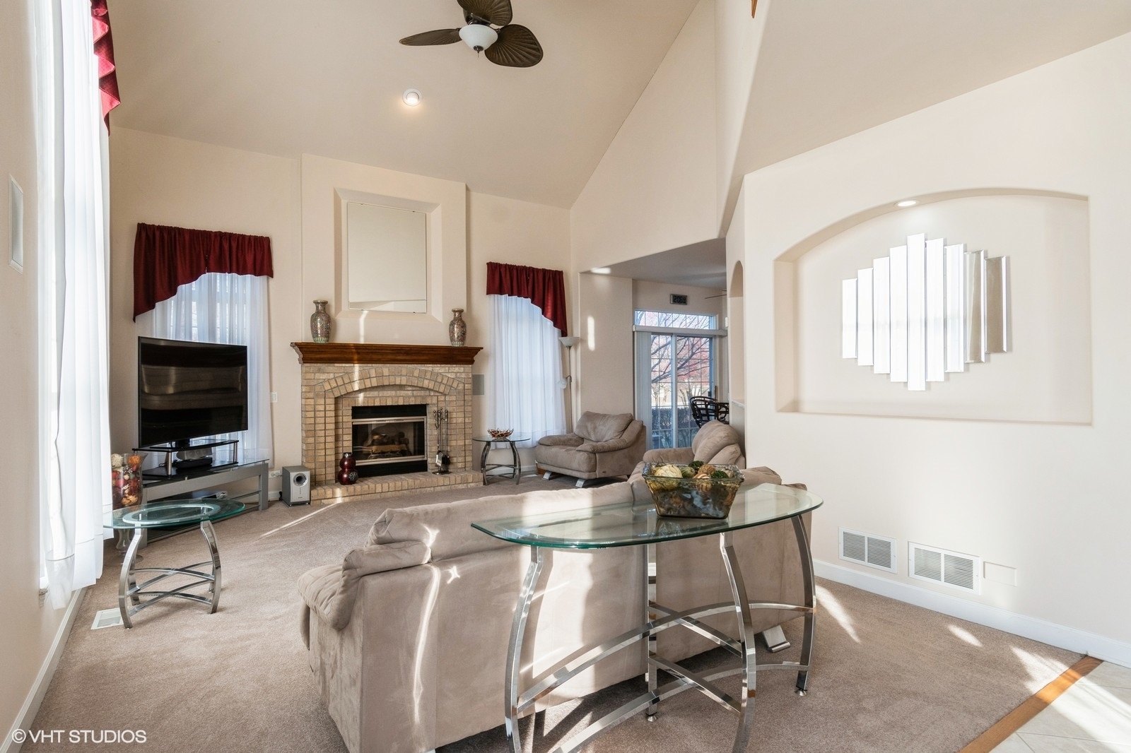 11976 Winterberry Lane Plainfield, IL 60585 - Photo 8 of 22 a living room with furniture a fireplace and a flat screen tv