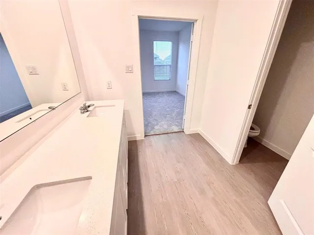 a bathroom with a double vanity sink and a mirror