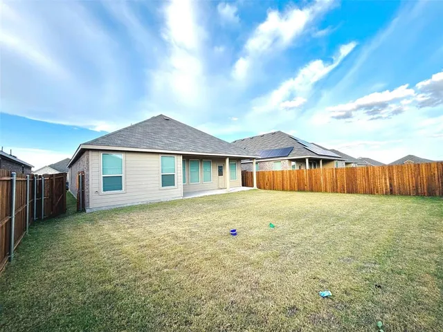 a front view of a house with yard and garage