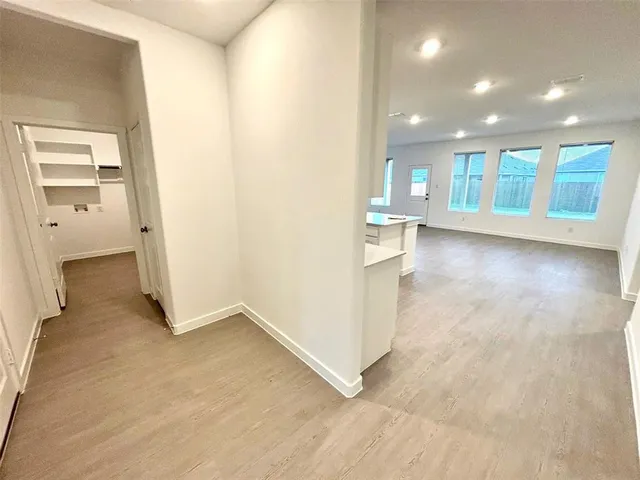 a view of kitchen with stainless steel appliances refrigerator oven microwave and cabinets