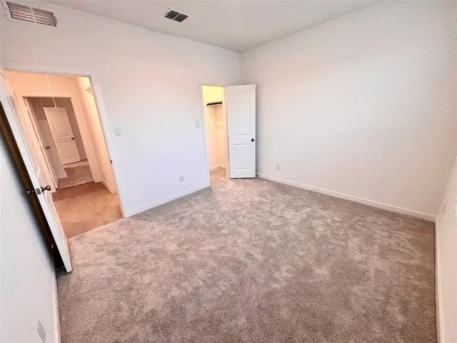 a view of a kitchen with a sink and dishwasher with wooden floor