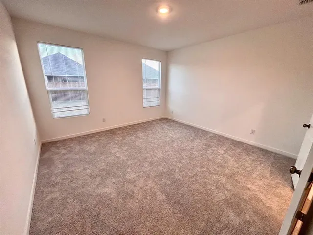 a kitchen with a sink a stove and white cabinets