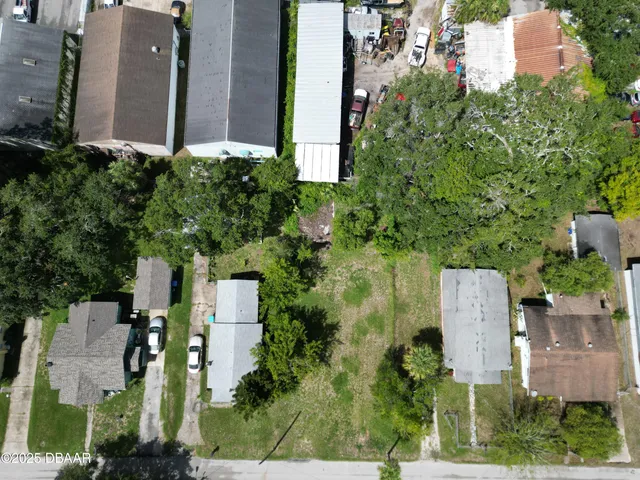 an aerial view of a house with outdoor space and street view