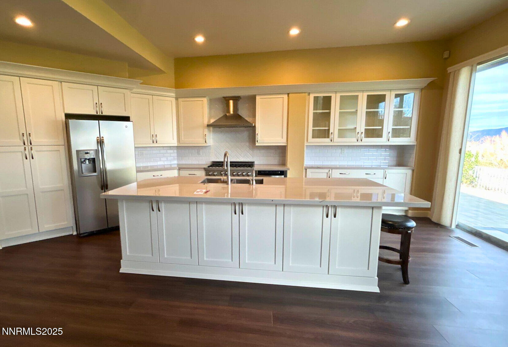6190 Carriage House Way Reno, NV 89519 - Photo 6 of 26 a kitchen with stainless steel appliances a refrigerator and wooden cabinets