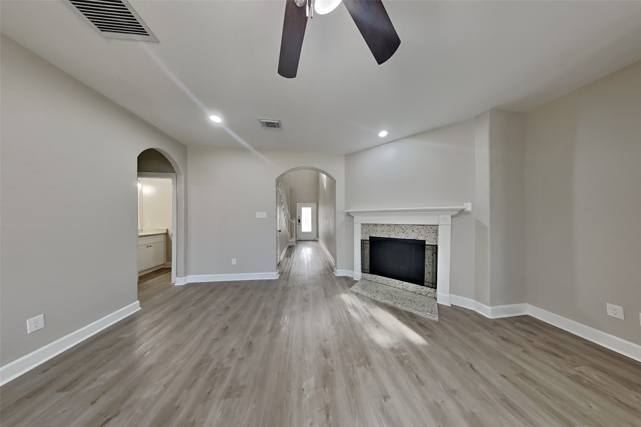 4718 Wild Bluebonnet Way Houston, TX 77084 - Photo 2 of 20 wooden floor in an empty room with a fireplace