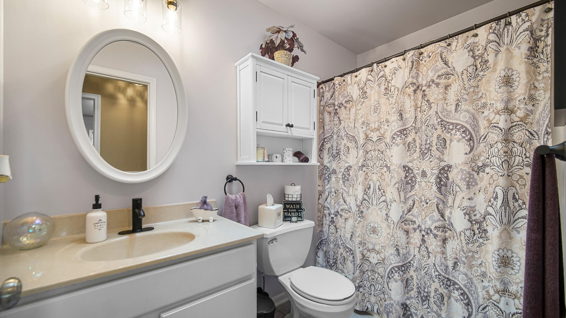 7313 West 91st Place Crown Point, IN 46307 - Photo 17 of 28 a bathroom with a toilet sink and mirror