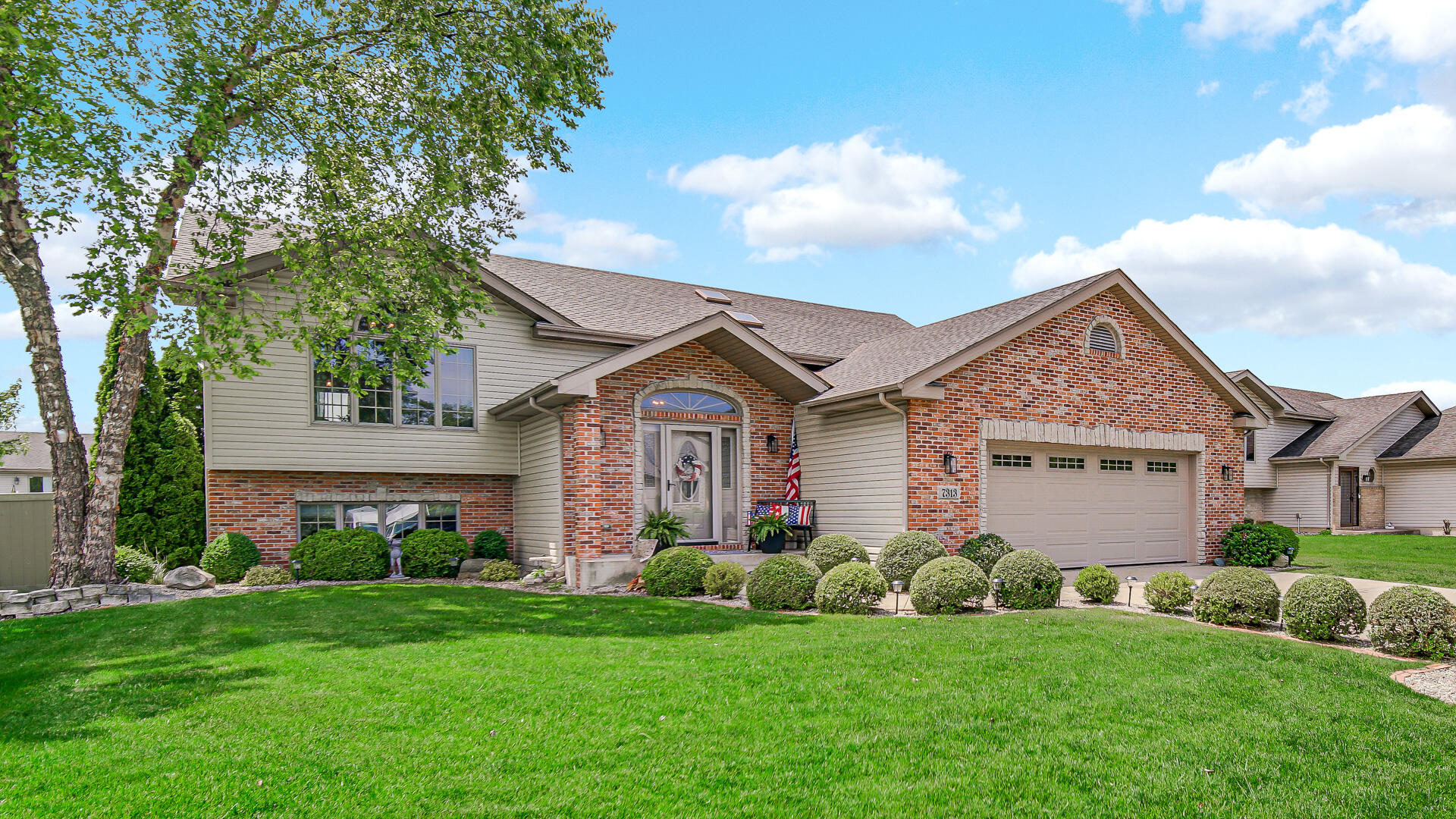 7313 West 91st Place Crown Point, IN 46307 - Photo 3 of 28 a view of a house with a big yard plants and large trees