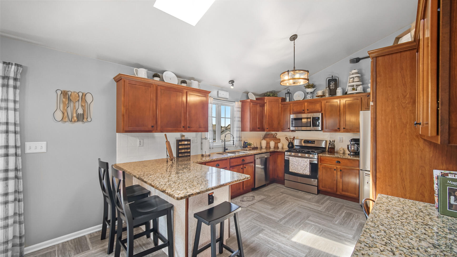 7313 West 91st Place Crown Point, IN 46307 - Photo 8 of 28 a kitchen with stainless steel appliances granite countertop a stove top oven a sink a dining table and chairs with wooden floor