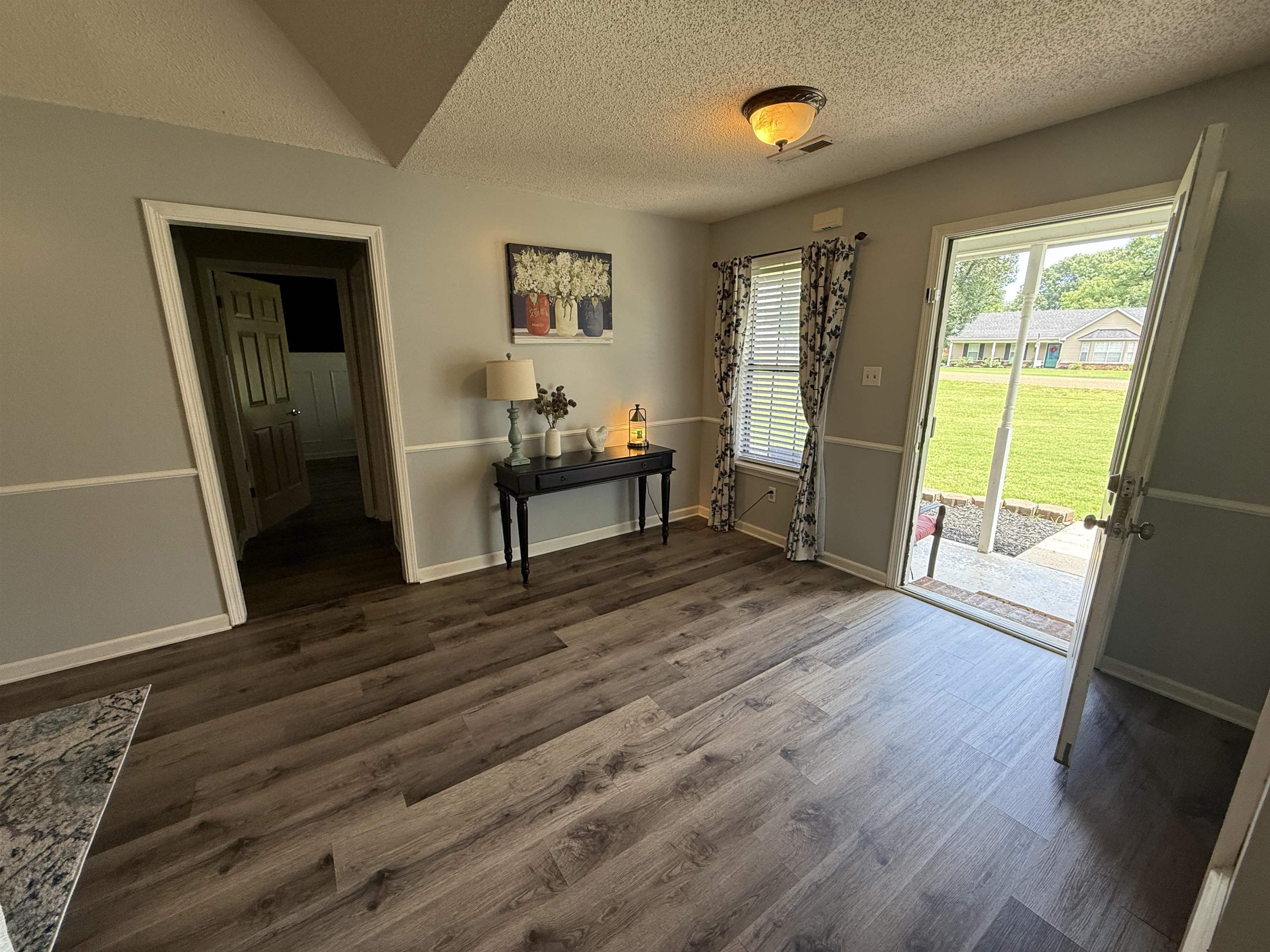 185 Mignon Road Atoka, TN 38004 - Photo 14 of 34 Entryway featuring wood-finish flooring and a light gray and white wall treatment