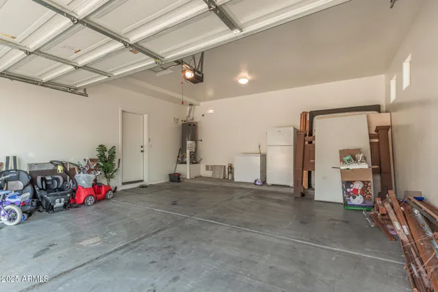 a view of a yard with plants and a lake view