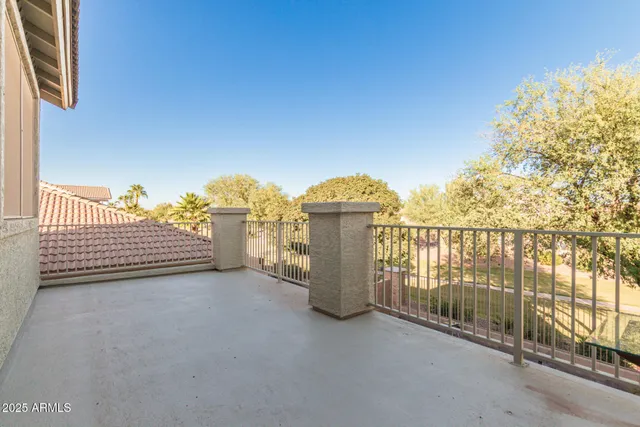 a view of a balcony with yard
