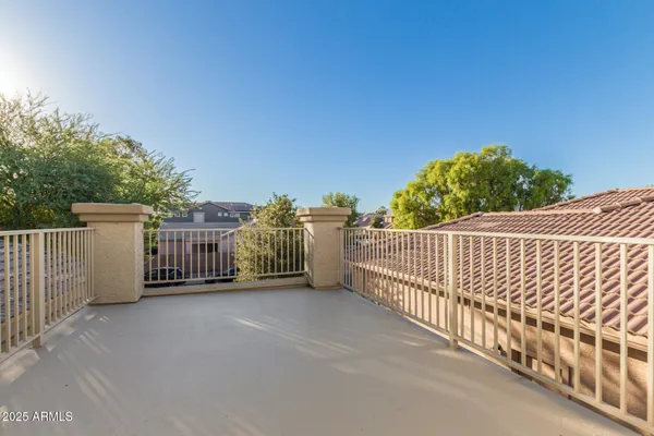 a view of backyard with large trees and plants