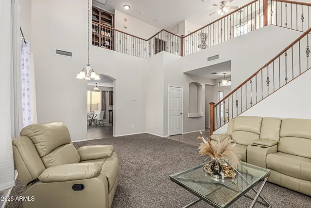 a living room with furniture and a chandelier