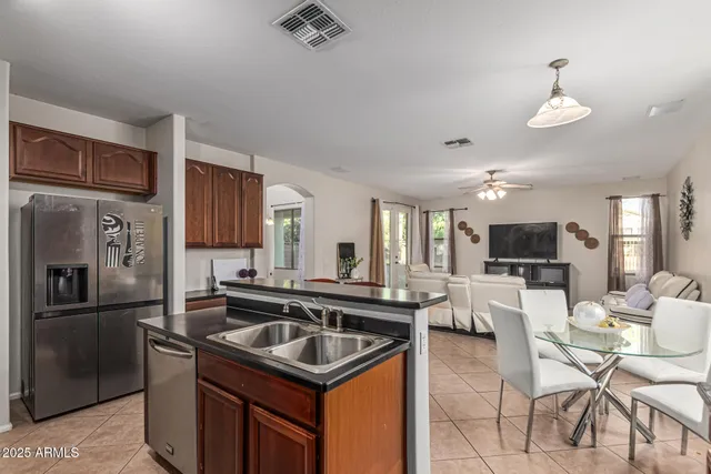 a kitchen view with stainless steel appliances granite countertop a sink stove and refrigerator