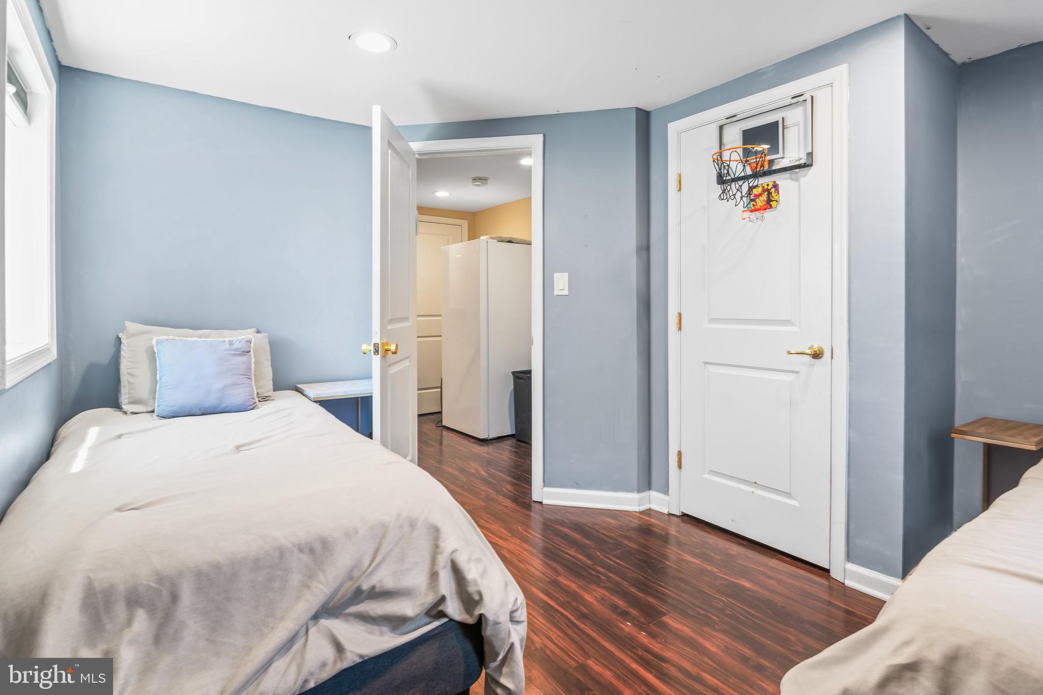 6308 Ivymount Road Baltimore, MD 21209 - Photo 16 of 22 a bedroom with a bed and wooden floor