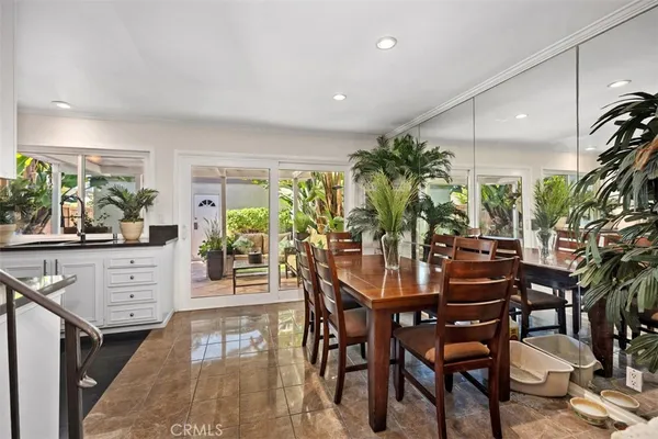 a view of a dining room with furniture and a potted plant