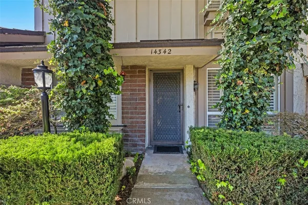 a view of a house with potted plants