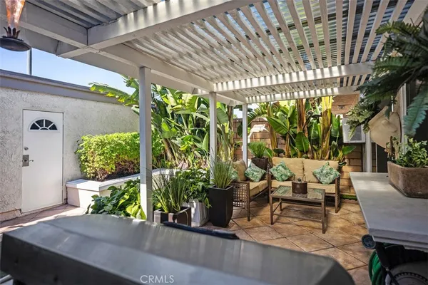 a view of a patio with table and chairs potted plants