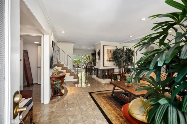 a living room with furniture and a potted plant