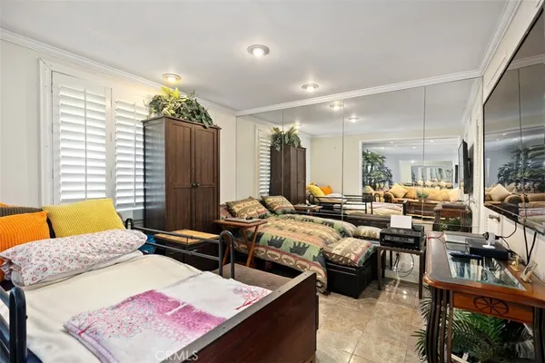 a living room with furniture wooden floor and a large window
