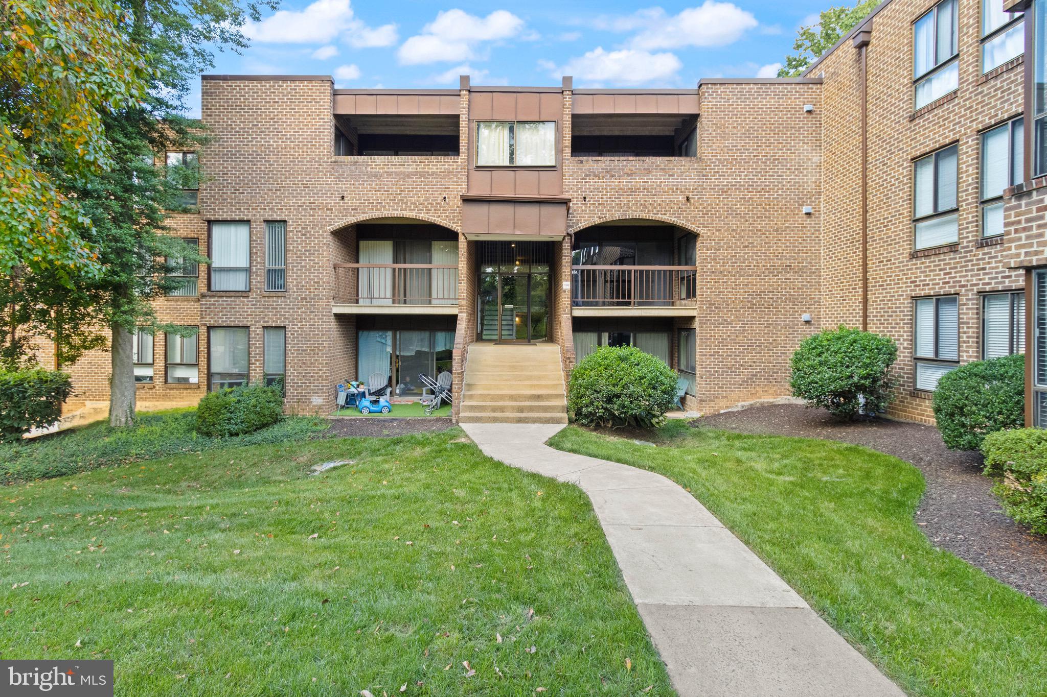 11240 Chestnut Grove Square, Unit 358 Reston, VA 20190 - Photo 1 of 31 a front view of a house with garden