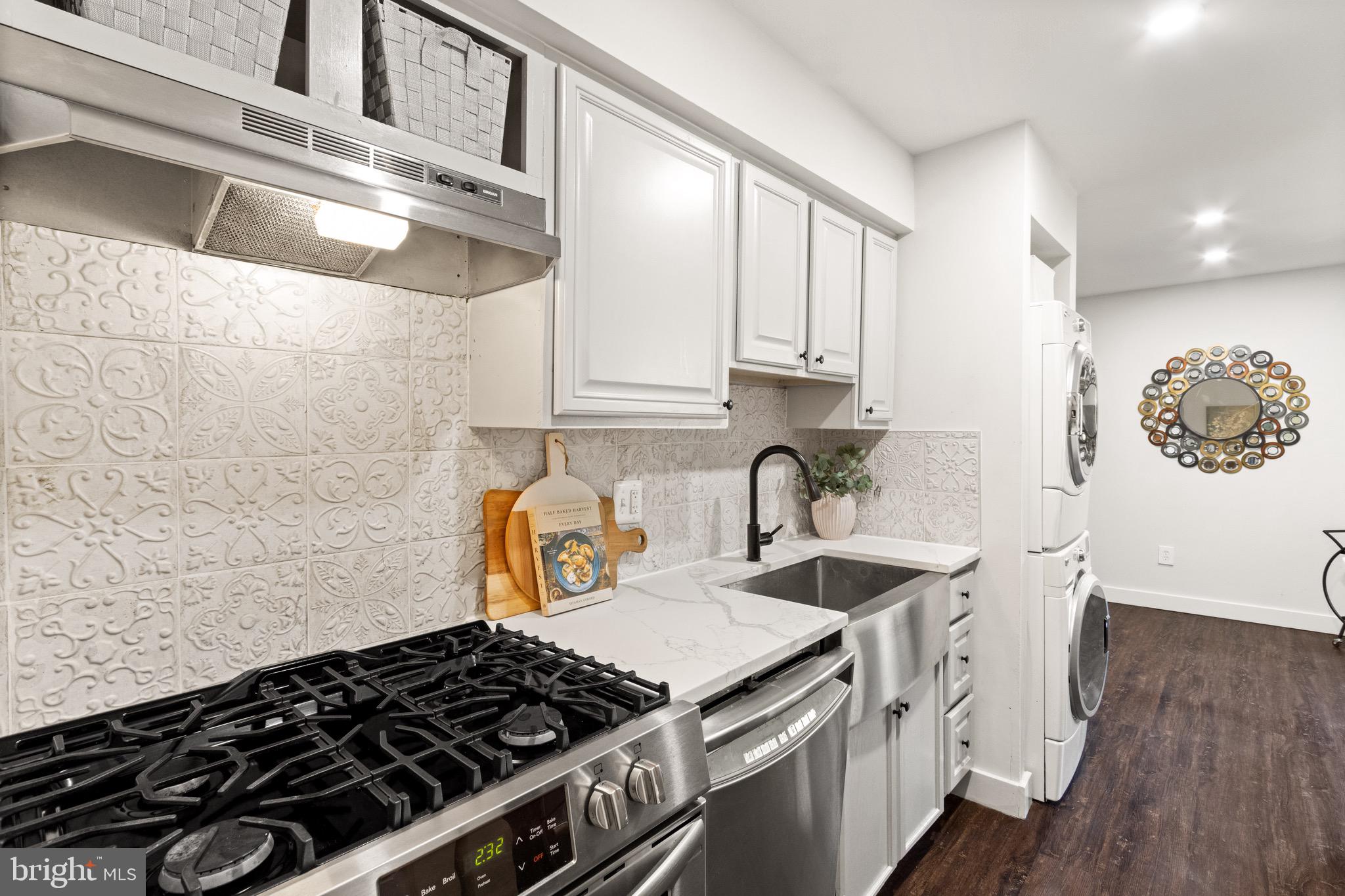 11240 Chestnut Grove Square, Unit 358 Reston, VA 20190 - Photo 12 of 31 a kitchen with a stove and a white wooden cabinets