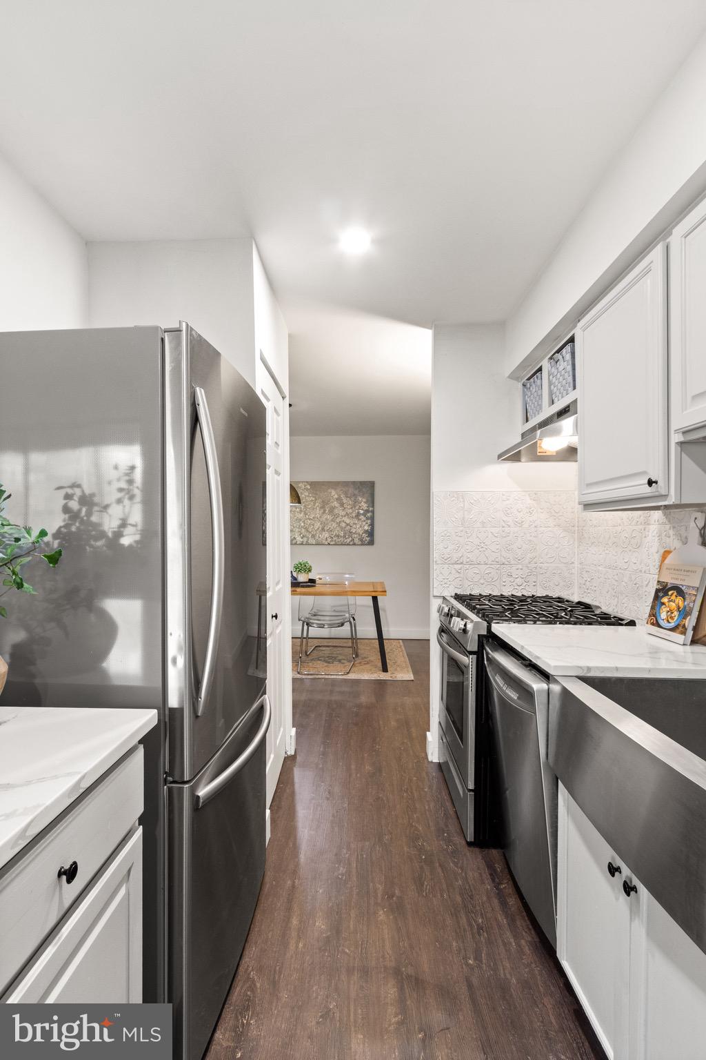 11240 Chestnut Grove Square, Unit 358 Reston, VA 20190 - Photo 14 of 31 a kitchen with stainless steel appliances granite countertop a refrigerator a stove and a sink