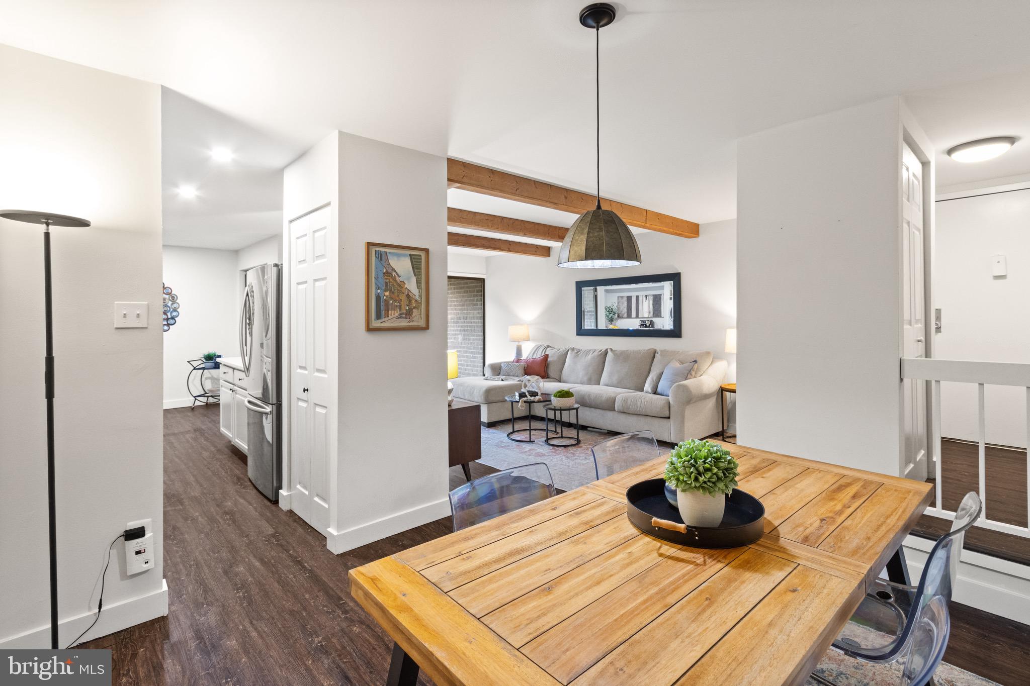 11240 Chestnut Grove Square, Unit 358 Reston, VA 20190 - Photo 16 of 31 a living room with furniture and wooden floor
