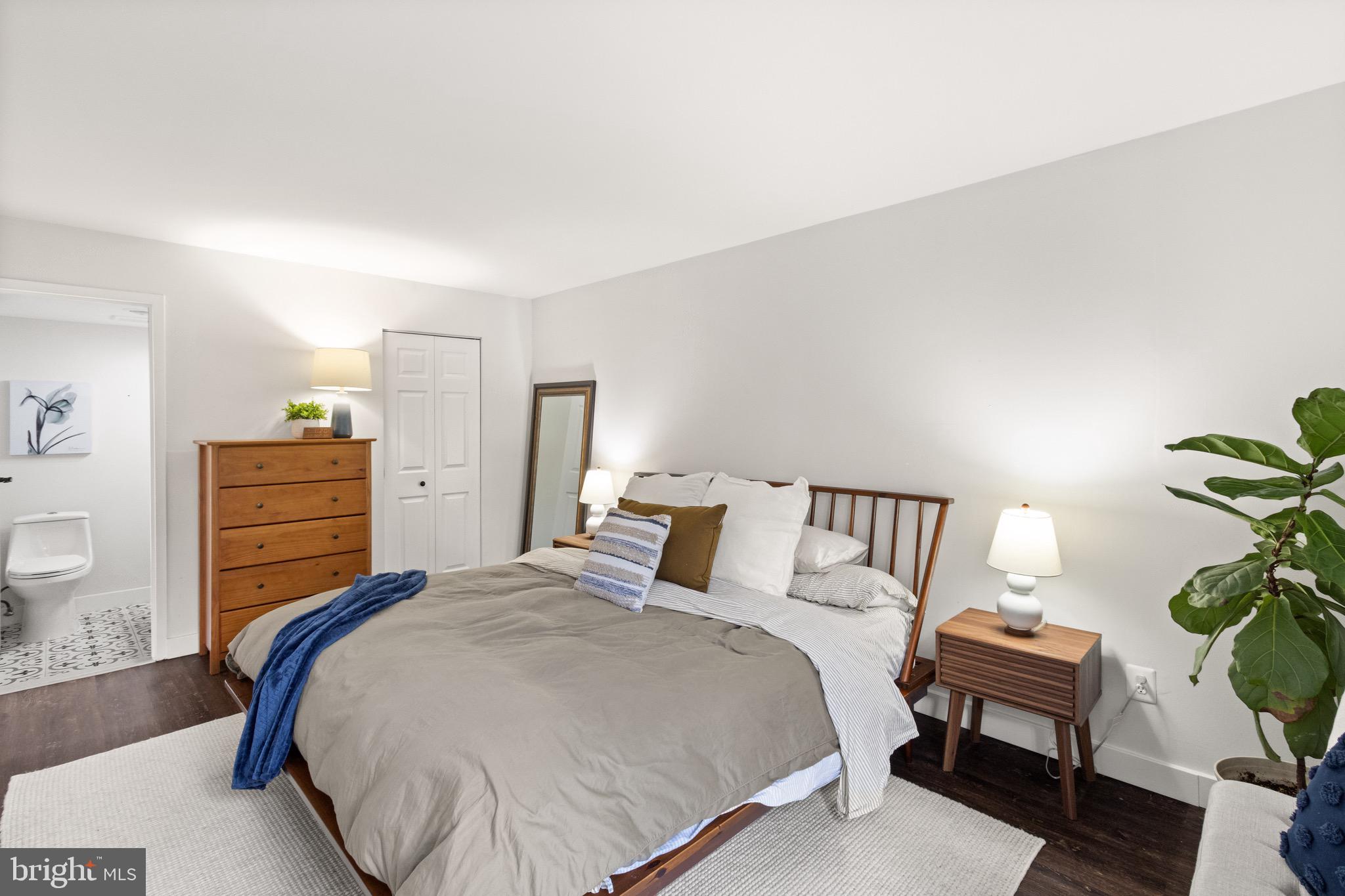 11240 Chestnut Grove Square, Unit 358 Reston, VA 20190 - Photo 22 of 31 a bed room with a bed and a chair