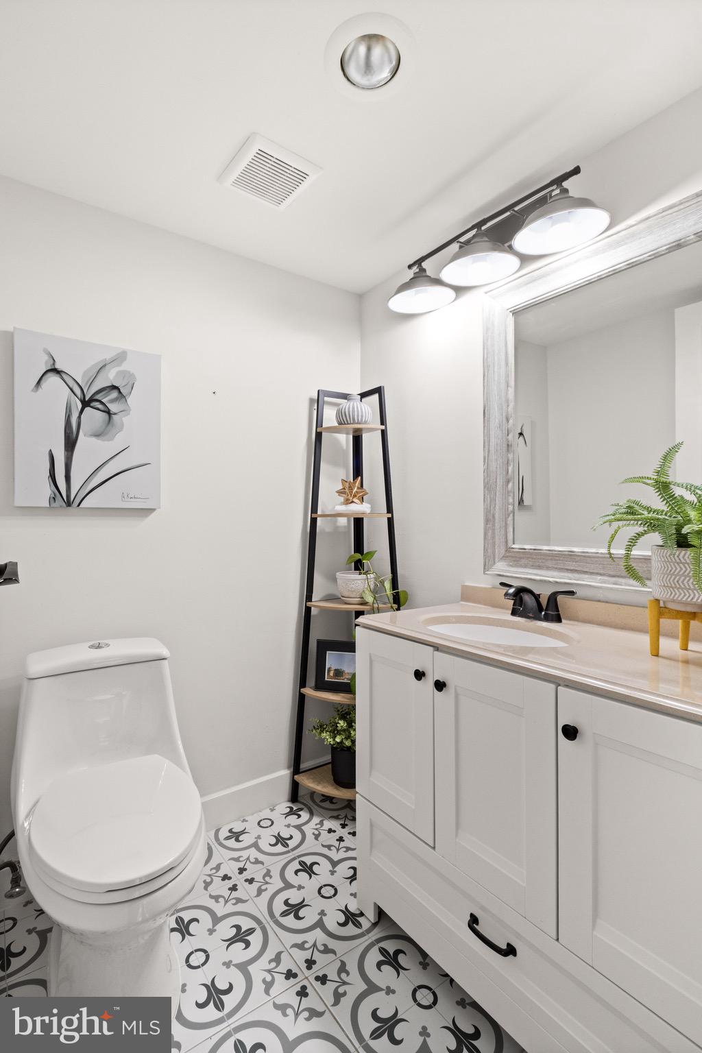 11240 Chestnut Grove Square, Unit 358 Reston, VA 20190 - Photo 24 of 31 a bathroom with a sink and a mirror