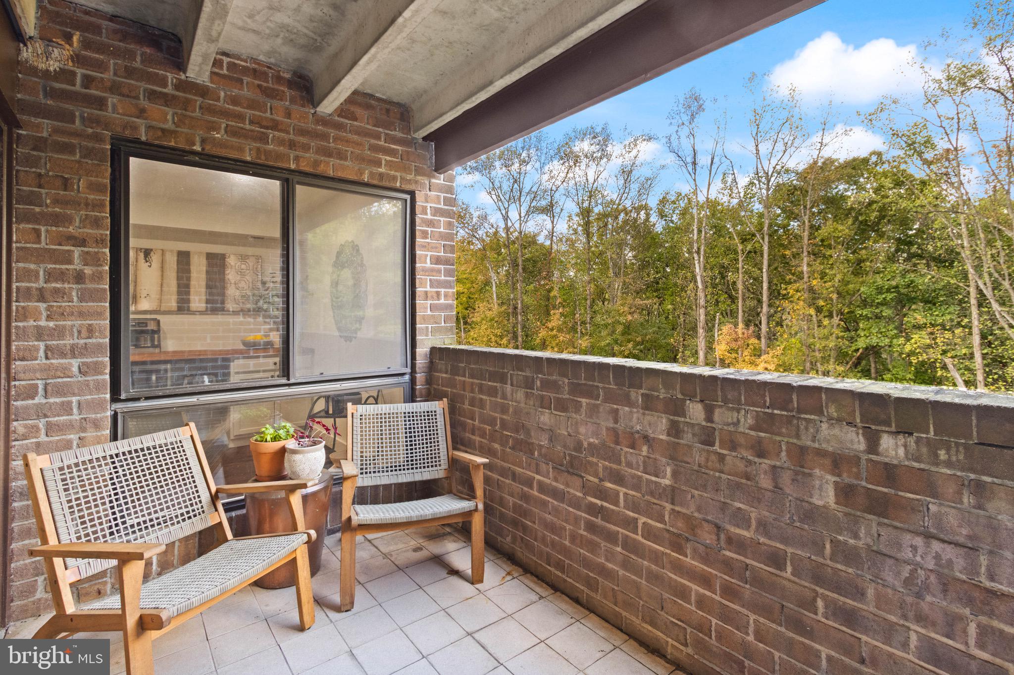 11240 Chestnut Grove Square, Unit 358 Reston, VA 20190 - Photo 26 of 31 a balcony with table and chairs
