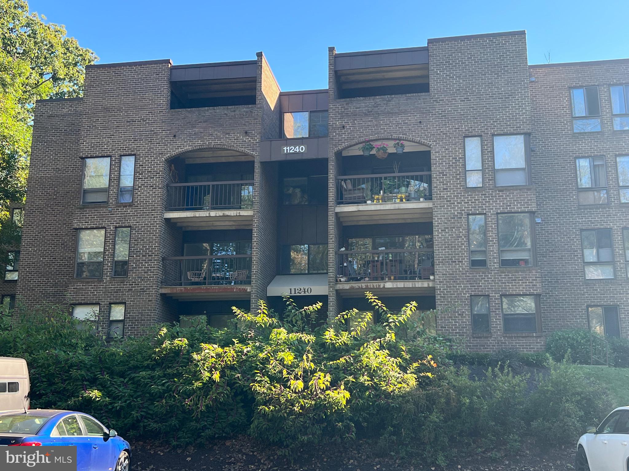 11240 Chestnut Grove Square, Unit 358 Reston, VA 20190 - Photo 28 of 31 a front view of a building with a garden