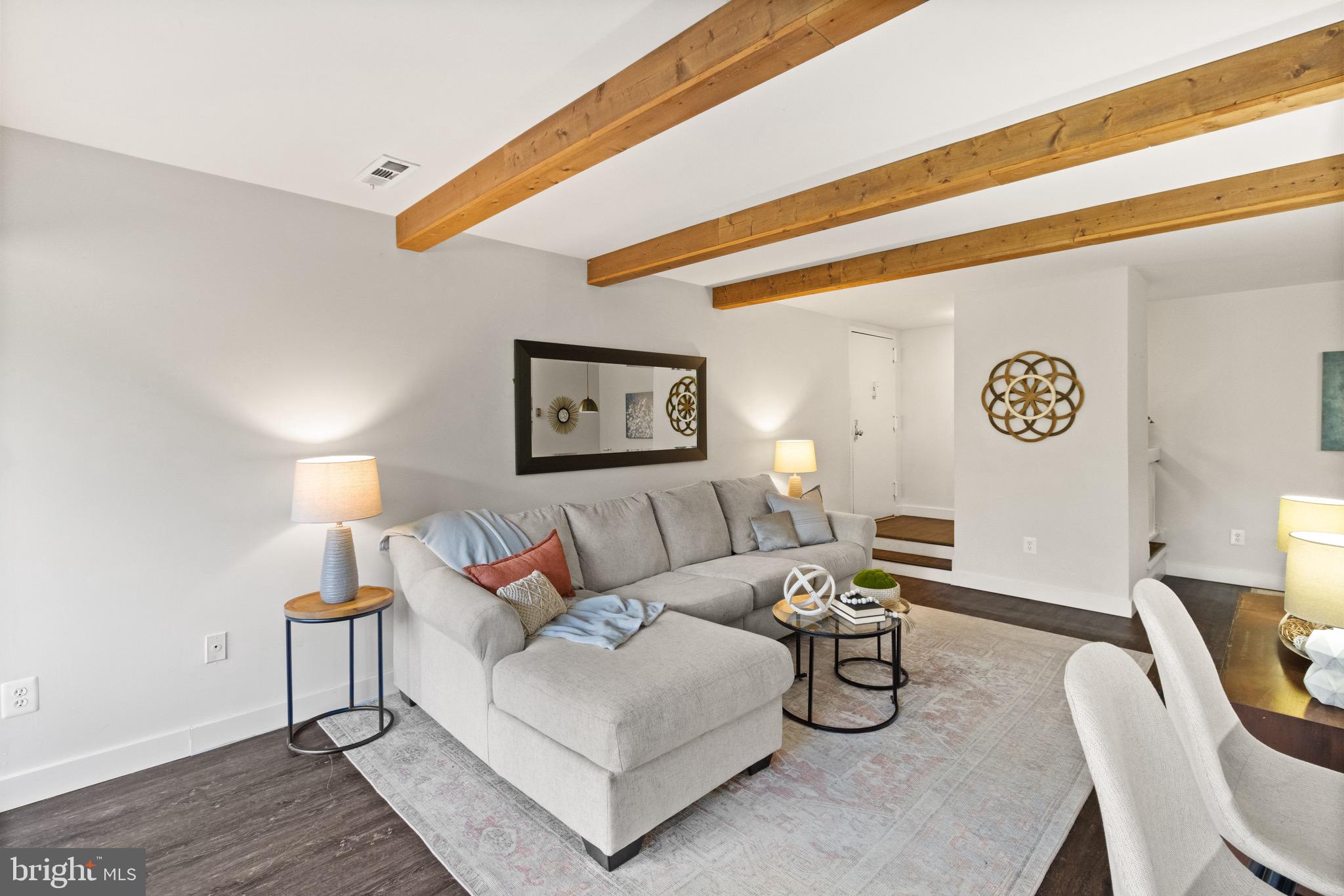 11240 Chestnut Grove Square, Unit 358 Reston, VA 20190 - Photo 5 of 31 a living room with furniture and a table