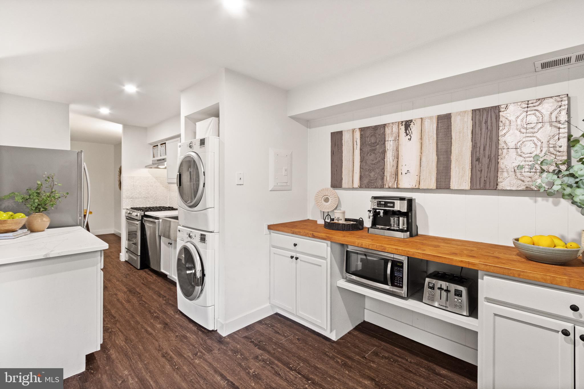 11240 Chestnut Grove Square, Unit 358 Reston, VA 20190 - Photo 8 of 31 a kitchen with stainless steel appliances a stove a sink and a refrigerator