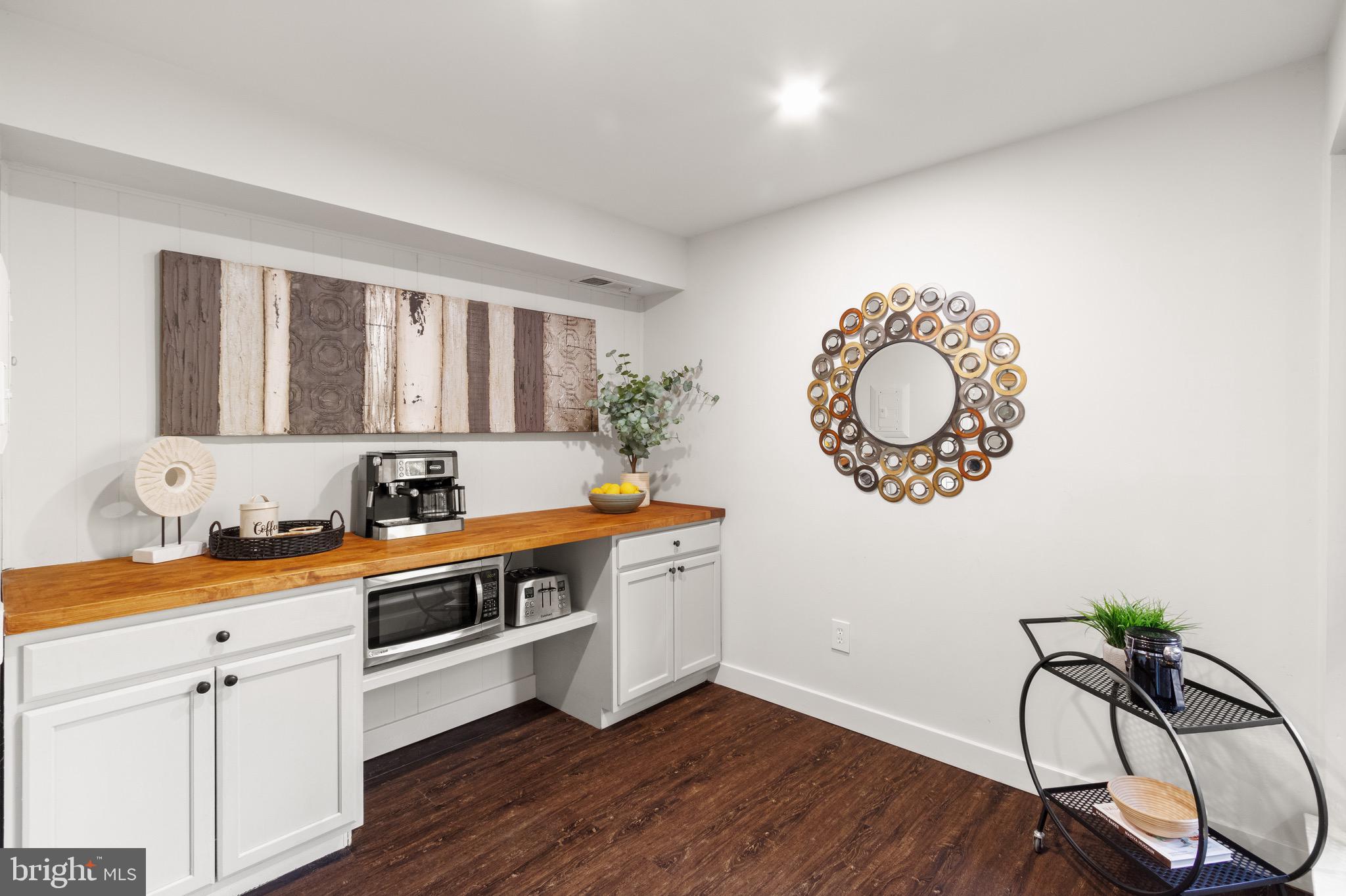 11240 Chestnut Grove Square, Unit 358 Reston, VA 20190 - Photo 9 of 31 a kitchen with a sink a stove cabinets and wooden floor