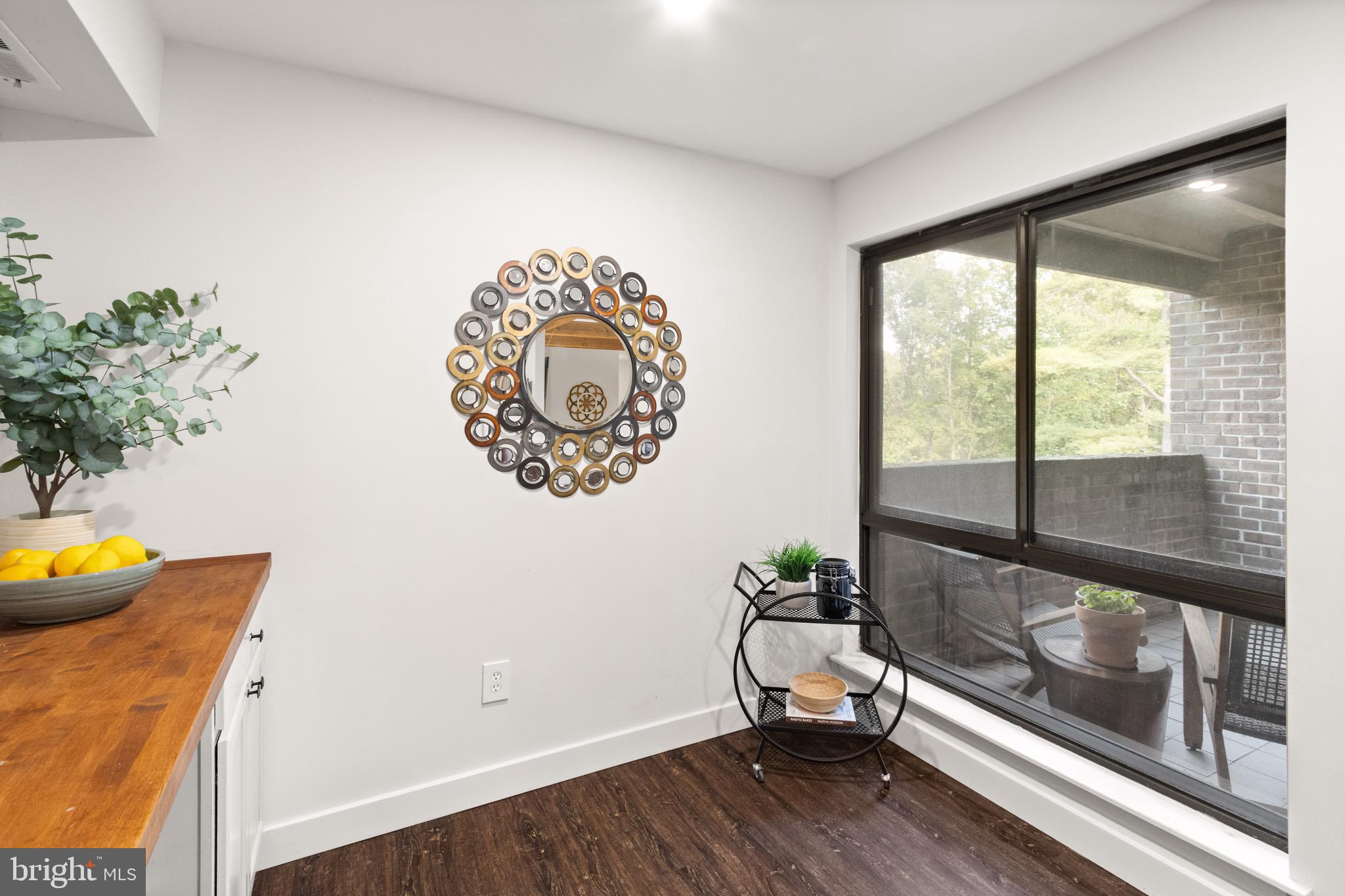 11240 Chestnut Grove Square, Unit 358 Reston, VA 20190 - Photo 10 of 31 a view of a room with a window and wooden floor